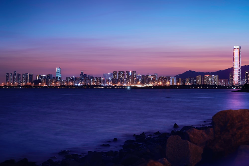 a view of a city at night from the ocean