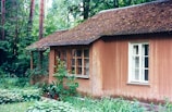 Rustic cabin with a warm brown roof blending into the natural surroundings.