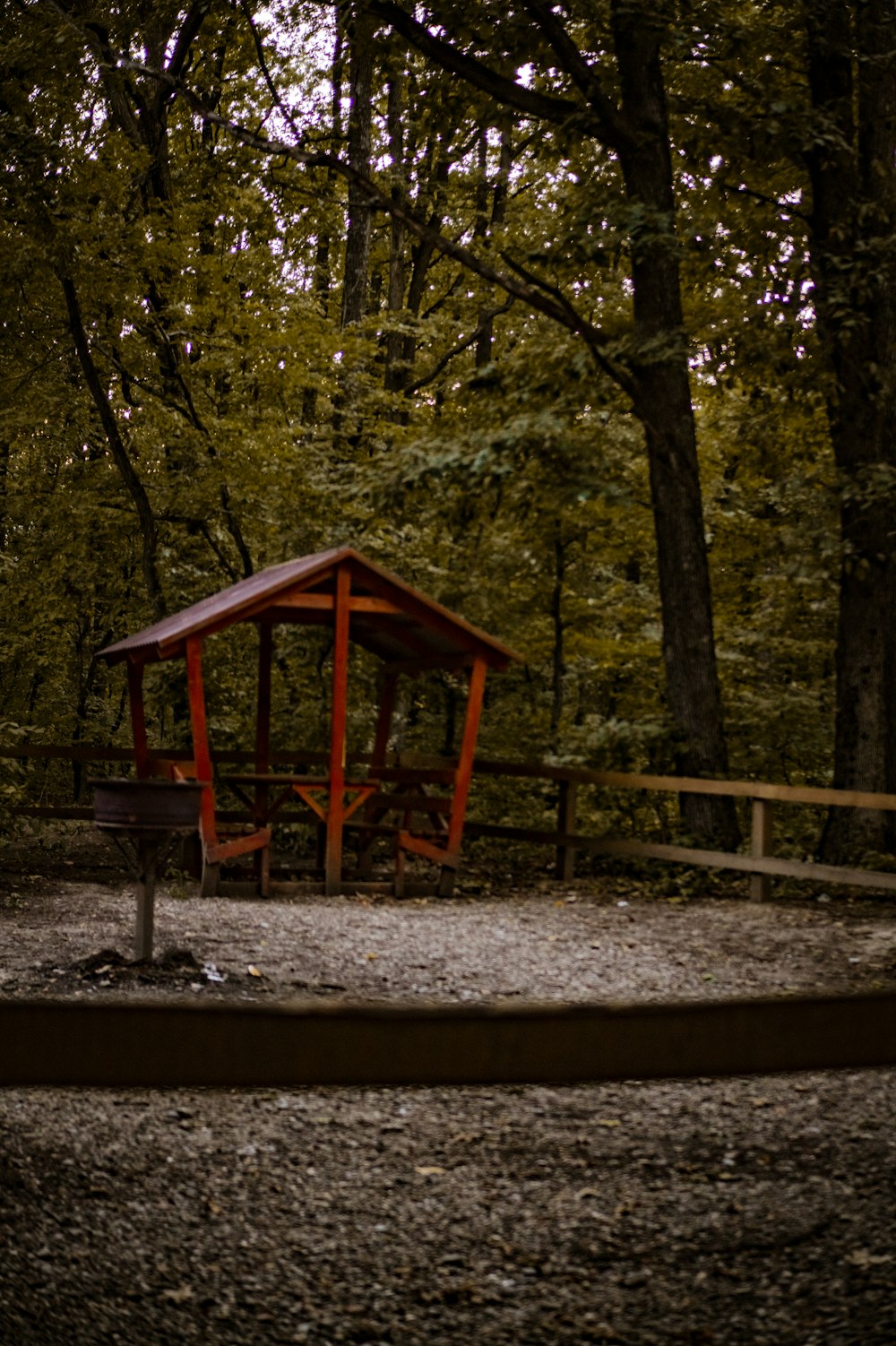 a small wooden shelter in the middle of a forest