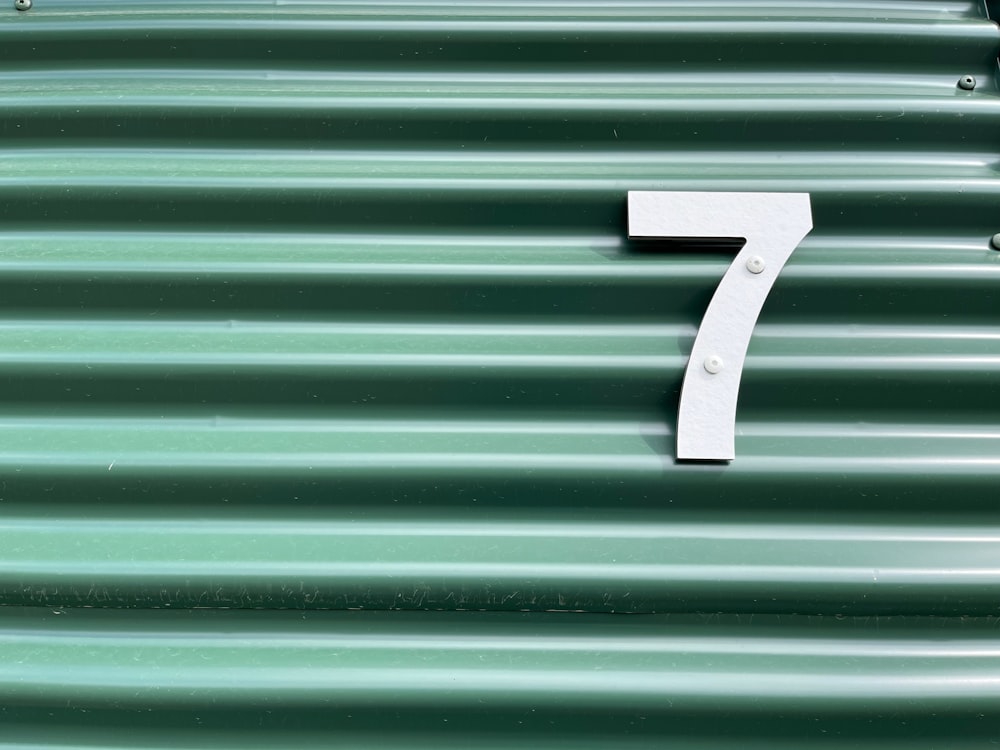 a number seven on a green metal surface
