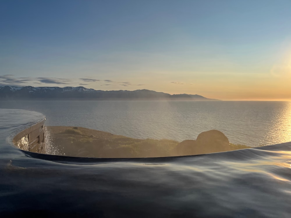 a boat floating on top of a large body of water