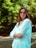 a woman with glasses standing in a park