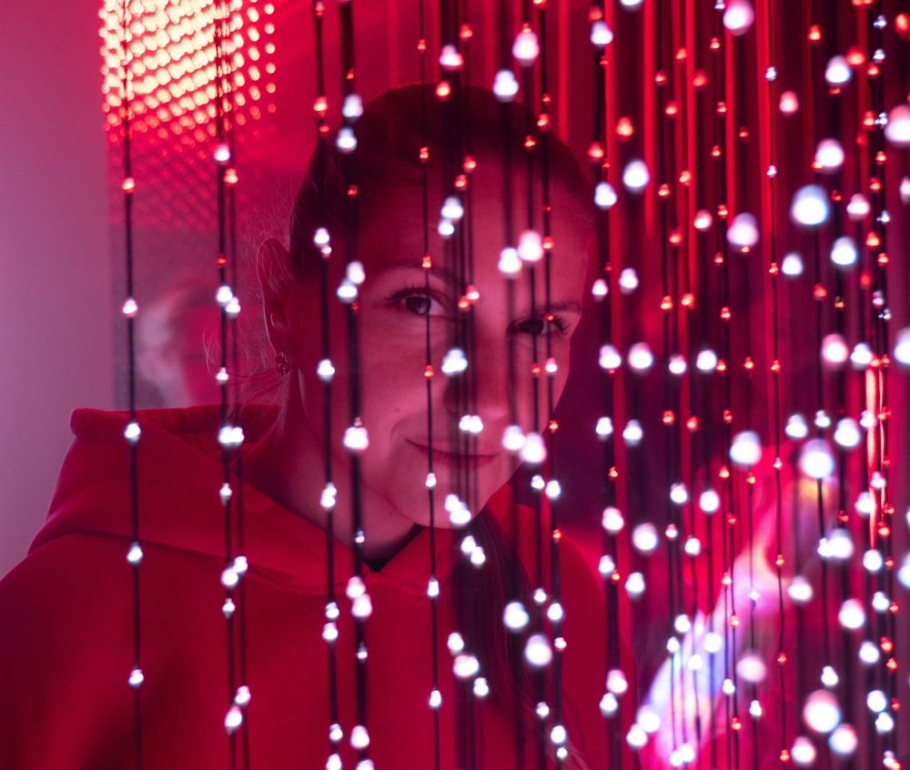 a woman standing in front of a red light