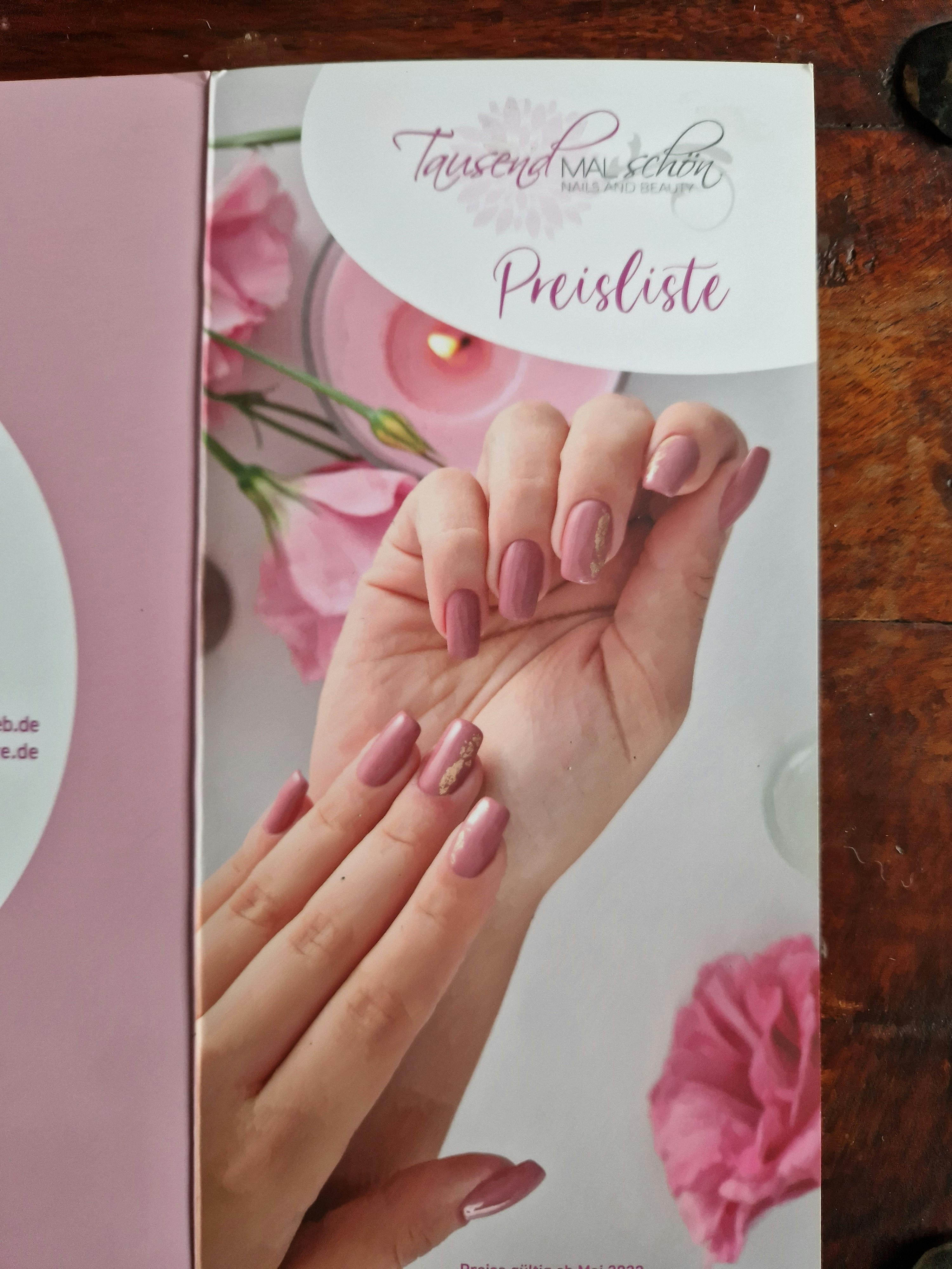 Beautiful nail art design with soft pink and gold accents on well-manicured nails