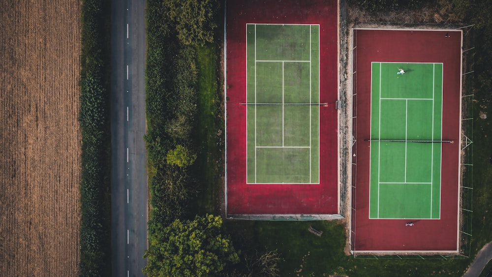 an aerial view of two tennis courts in the middle of a field