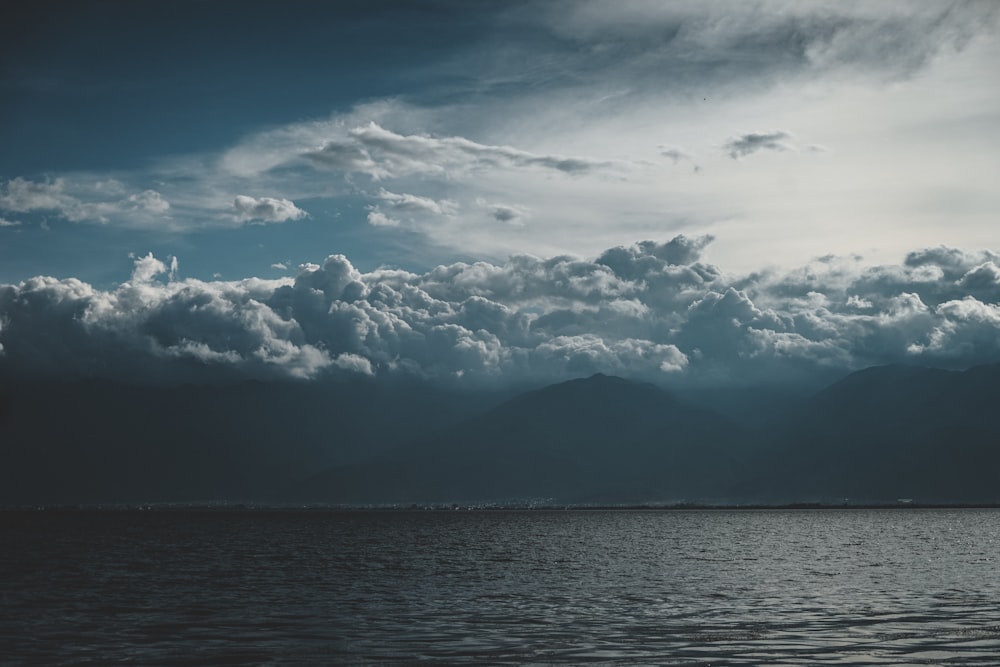 a large body of water under a cloudy sky