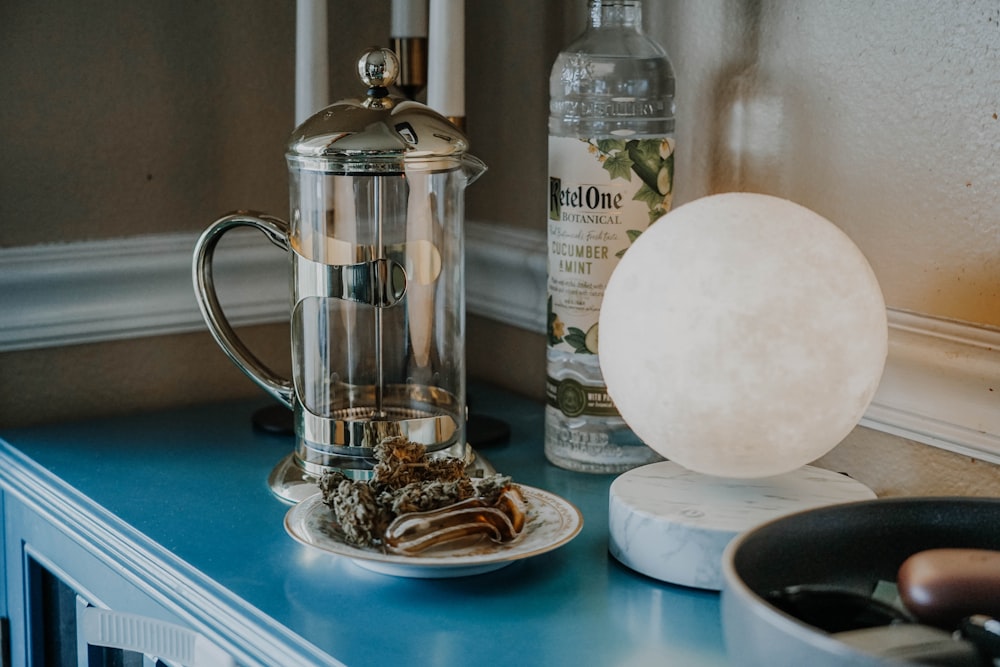 a coffee pot sitting on top of a blue counter