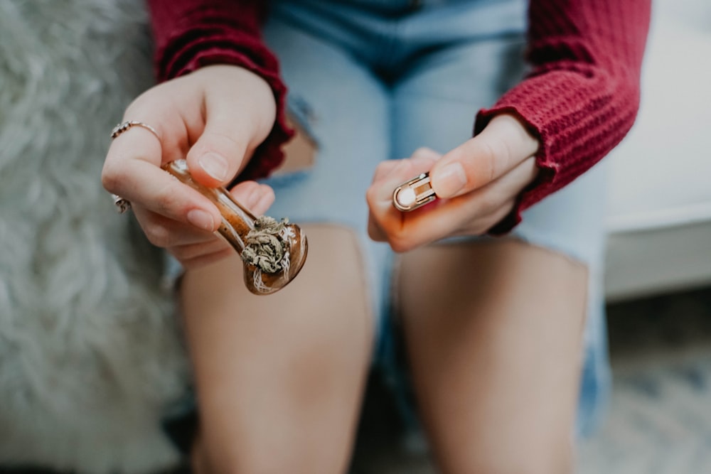 a woman sitting on a couch holding two rings