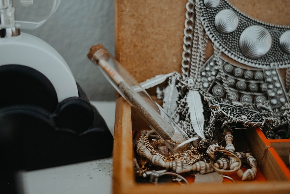 a wooden box filled with lots of jewelry