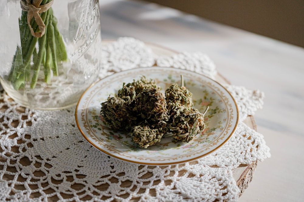 a plate of marijuana buds on a doily