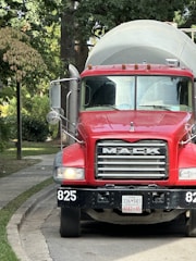 a large red truck parked on the side of a road