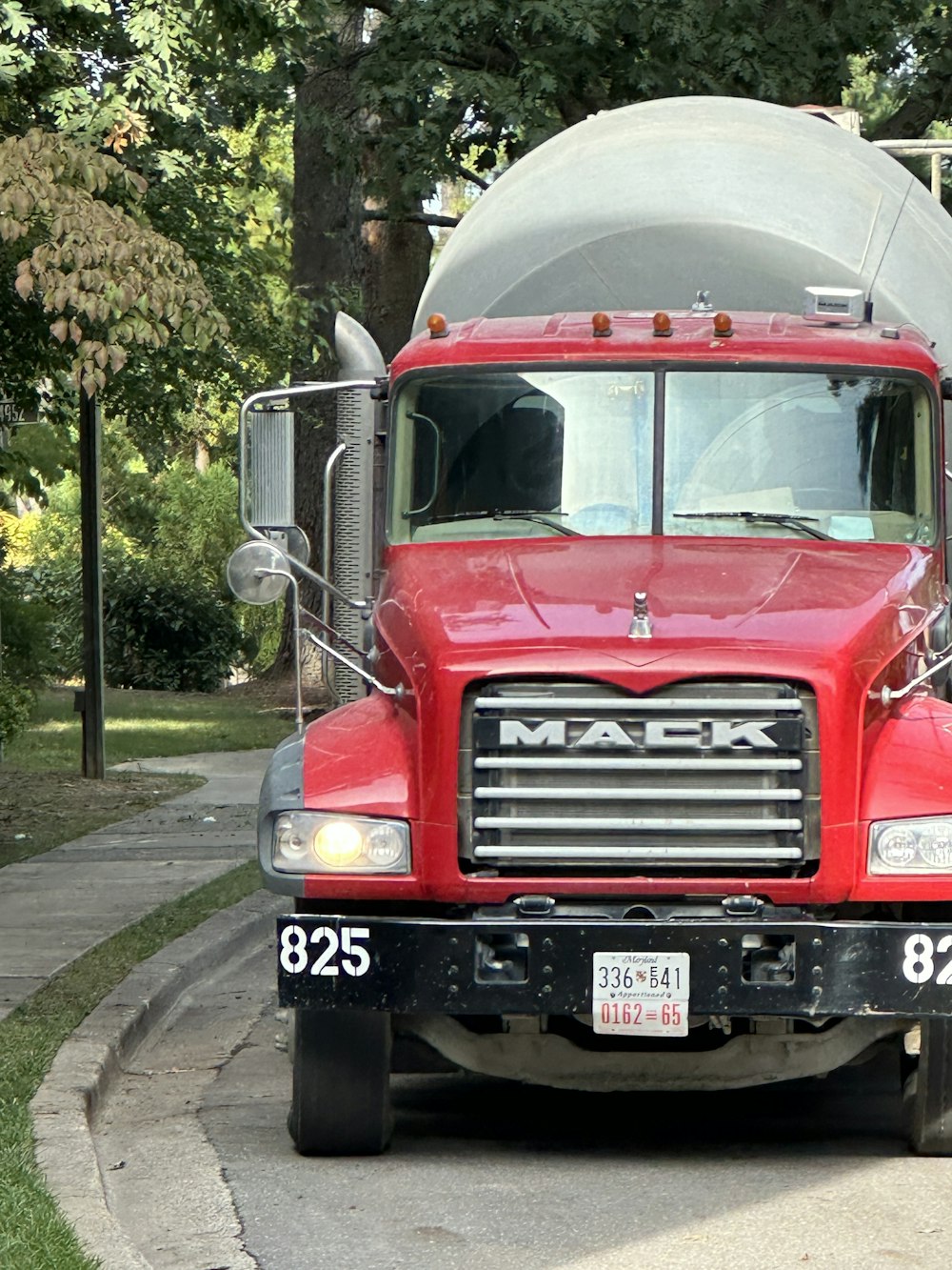 a large red truck parked on the side of a road