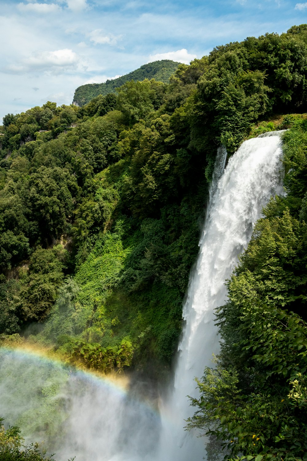 a waterfall with a rainbow in the middle of it