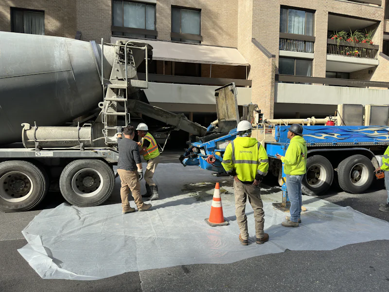 Mixer truck staged on a city street with the crew prepping the slab pour
