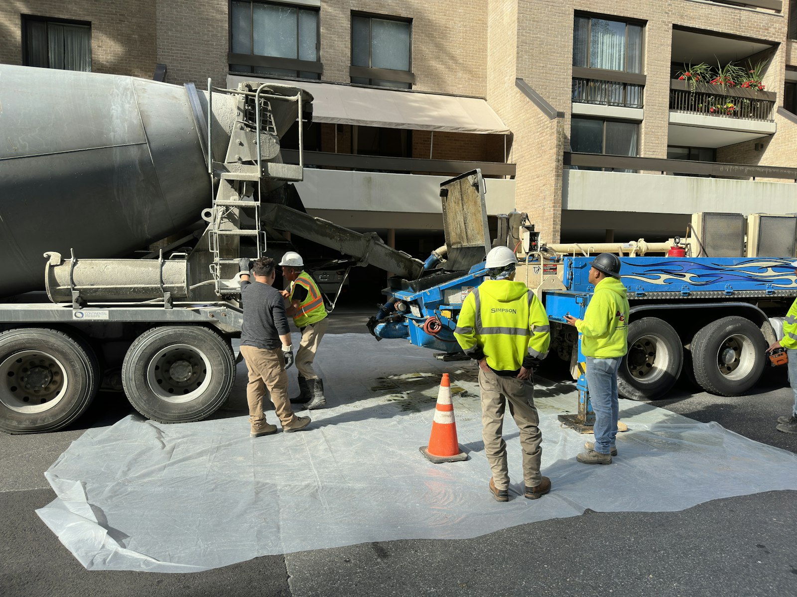 A crew working beside a mixer truck