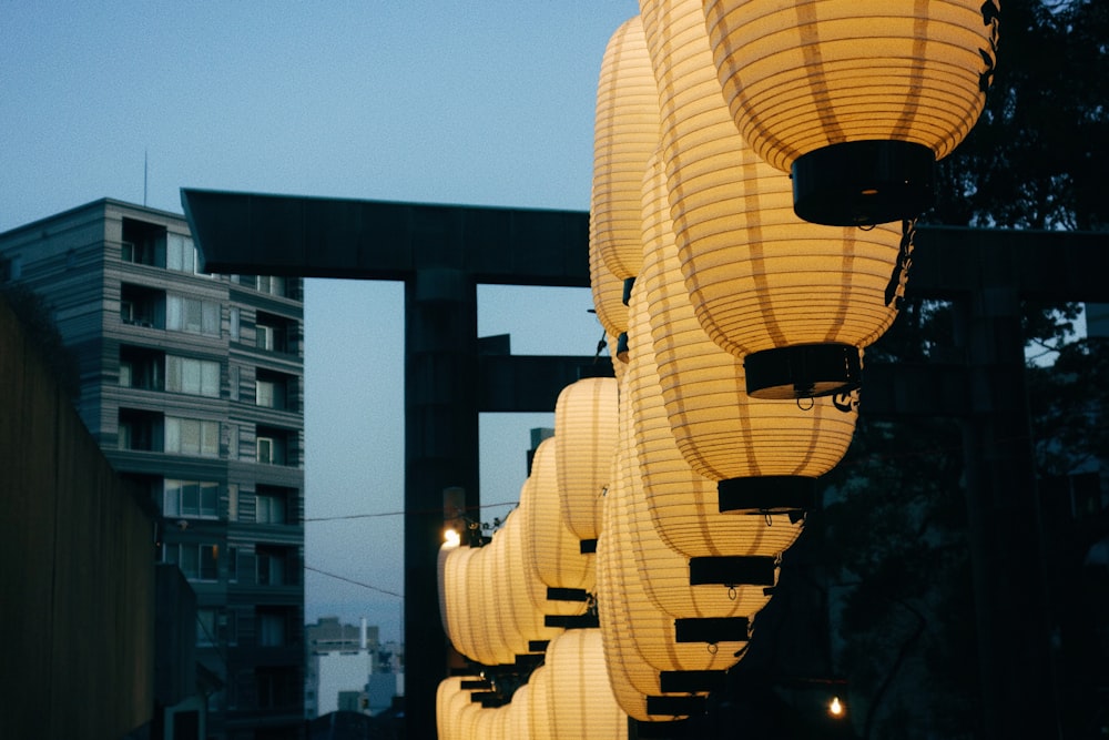 a row of lanterns hanging from the side of a building