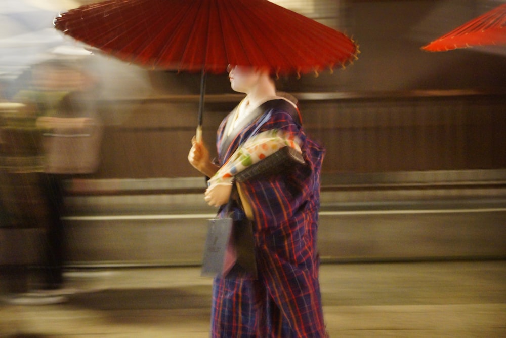 a woman in a kimono holding an umbrella