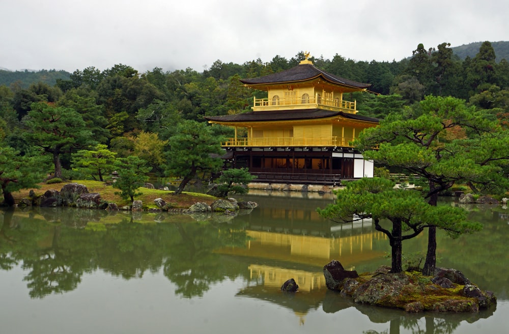 a yellow building sitting on top of a lush green field