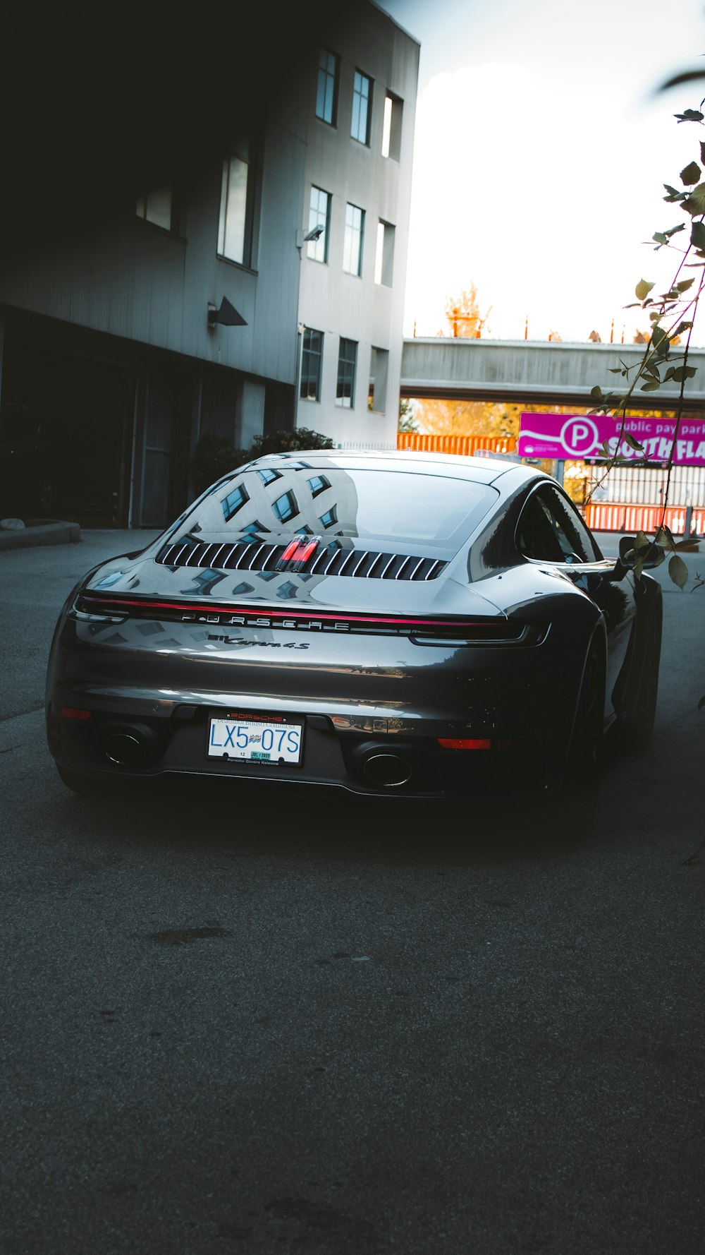 a black sports car parked in front of a building