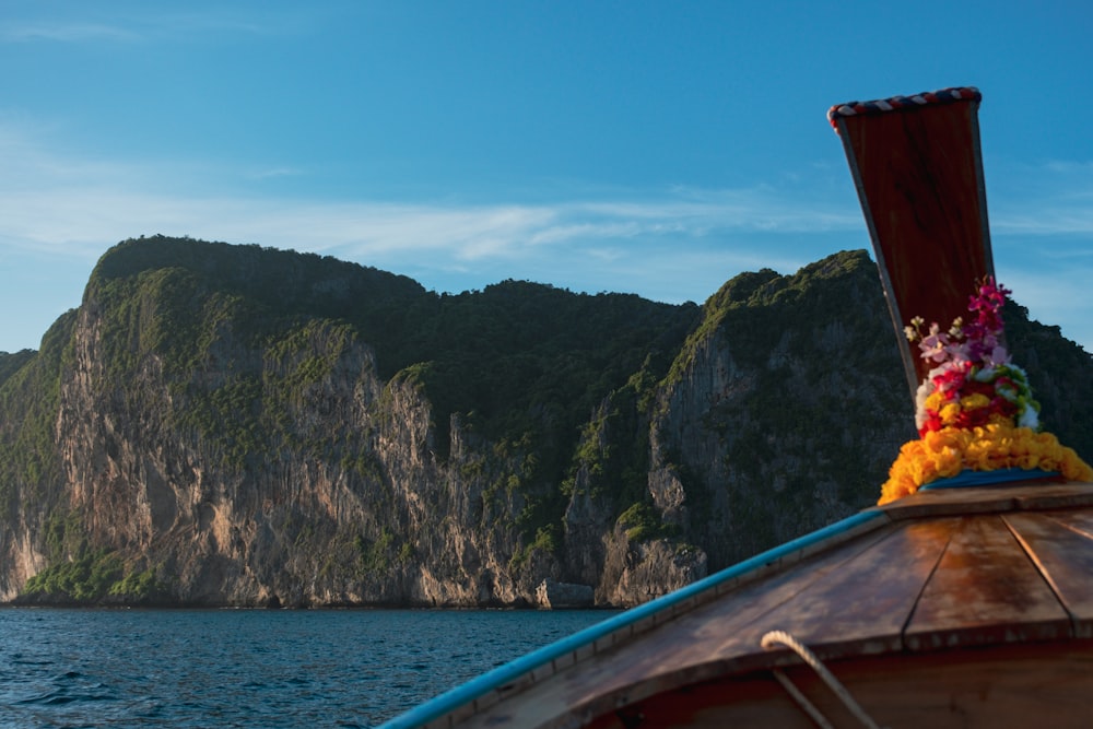 a boat with a bunch of flowers on the front of it