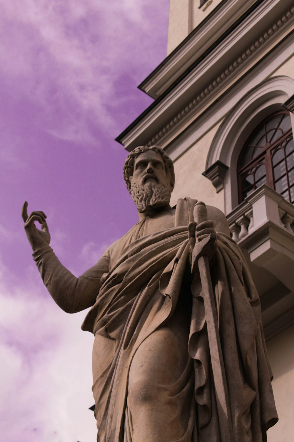 a statue of a man in front of a building