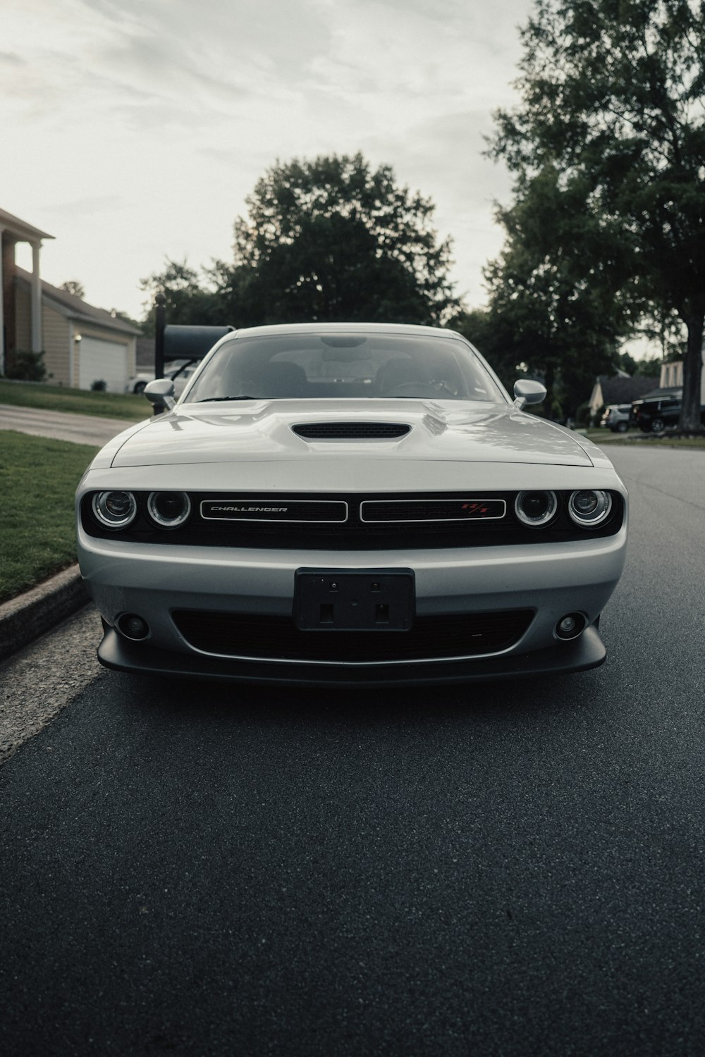 a white car parked on the side of a road