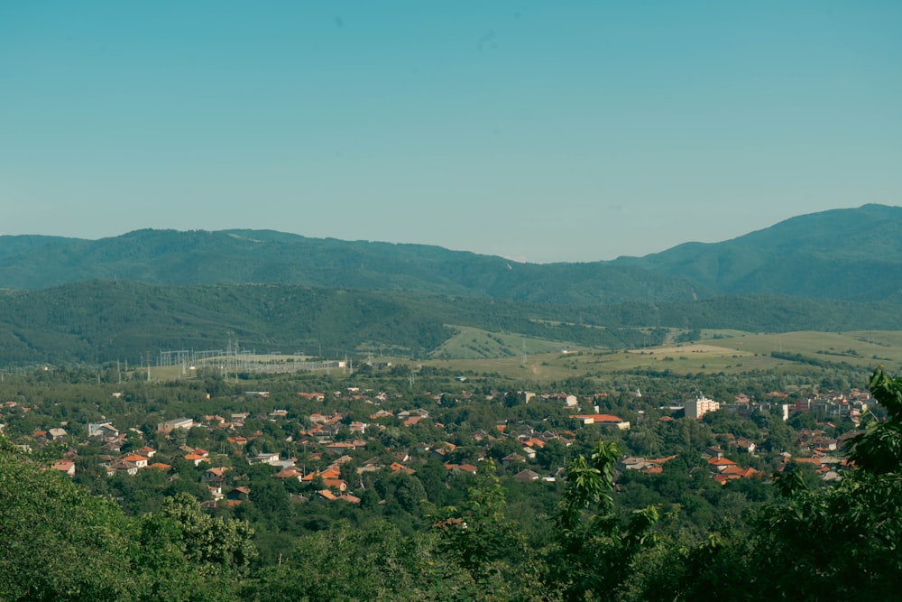 a scenic view of a town surrounded by mountains