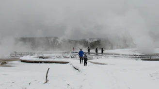A serene Icelandic landscape with travelers walking calmly on a snowy trail under soft pastel skies.