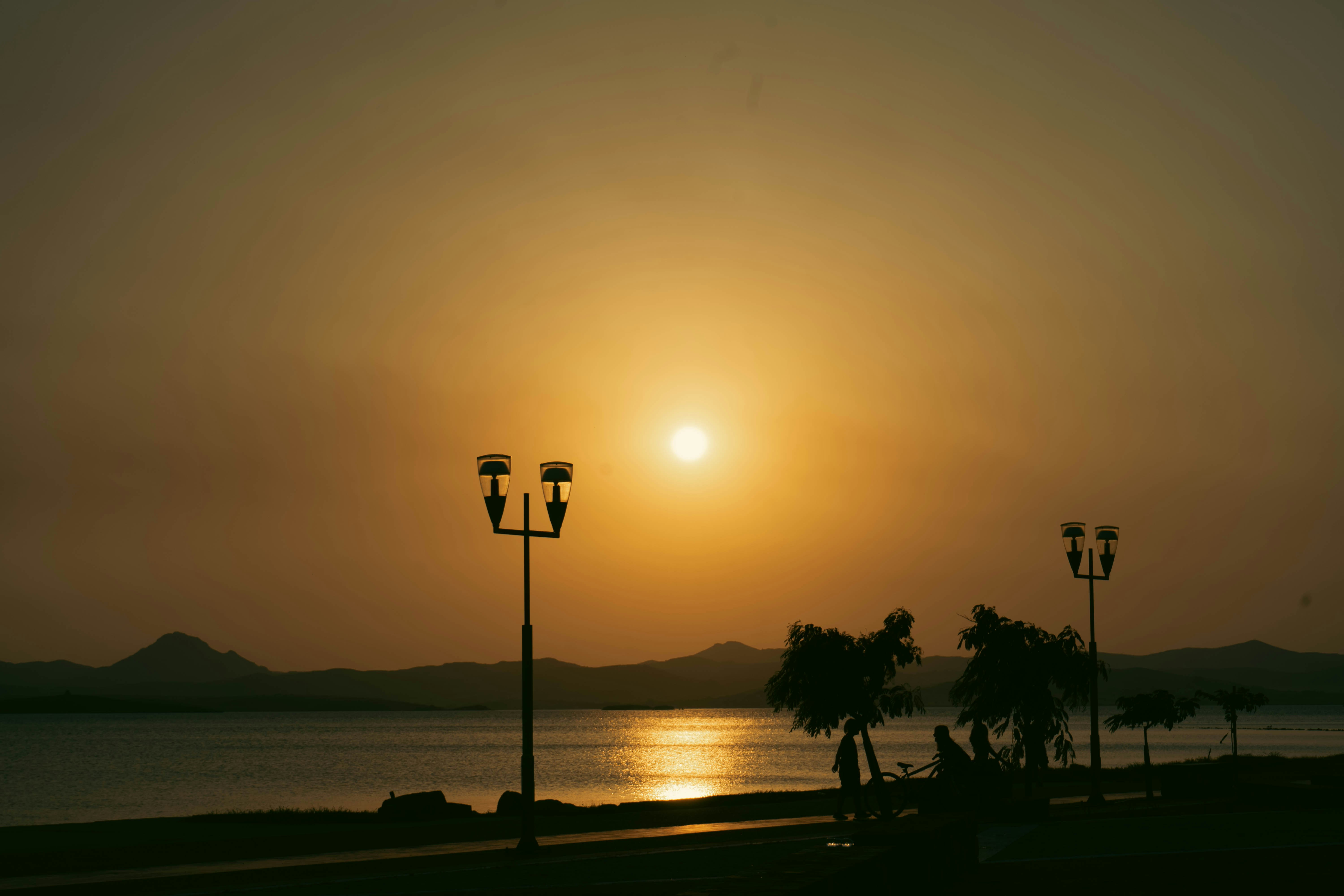 the sun is setting over a body of water
