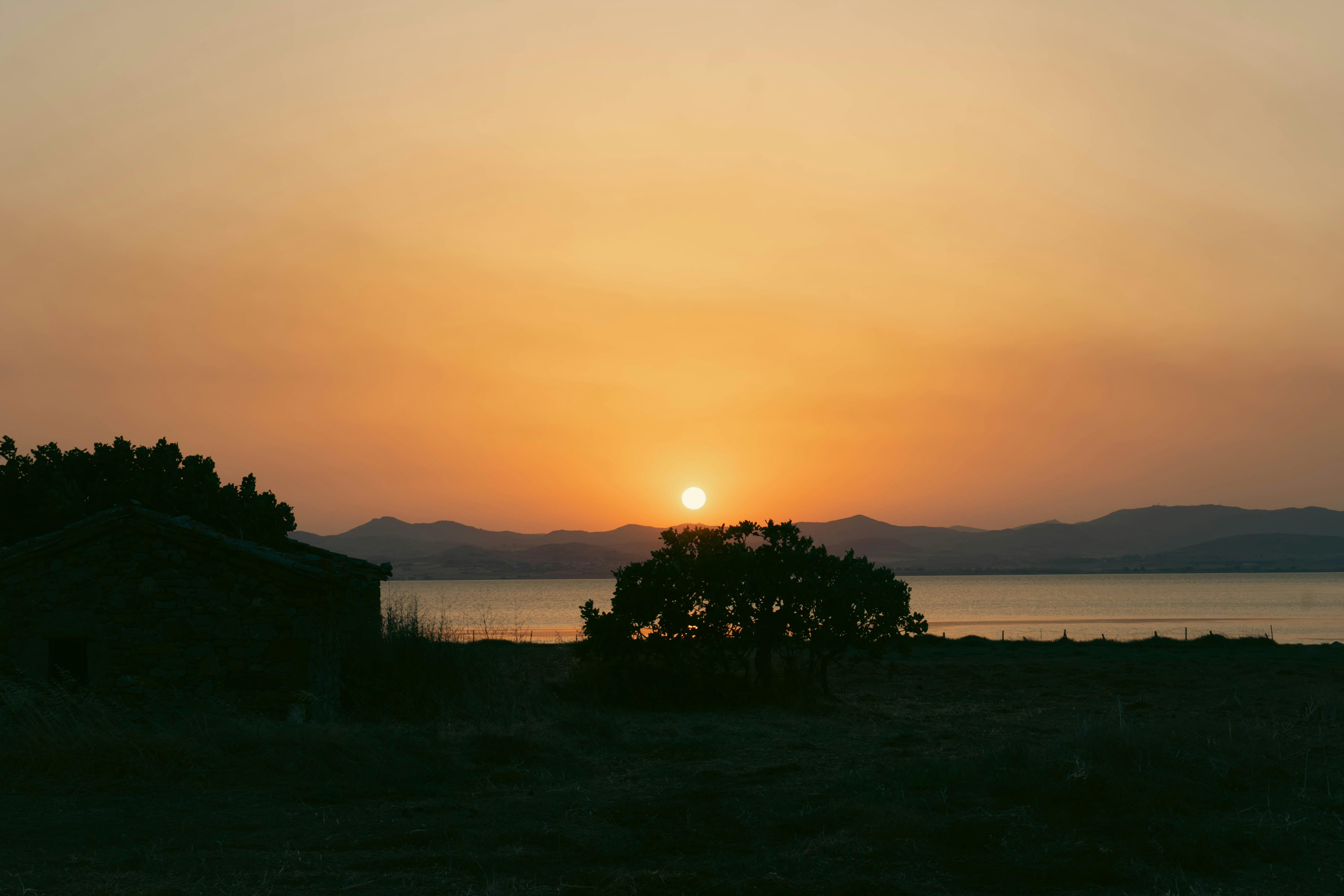 the sun is setting over a body of water