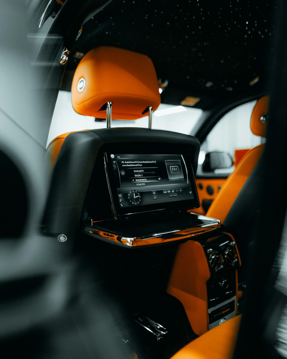 the interior of a car with orange and black trim