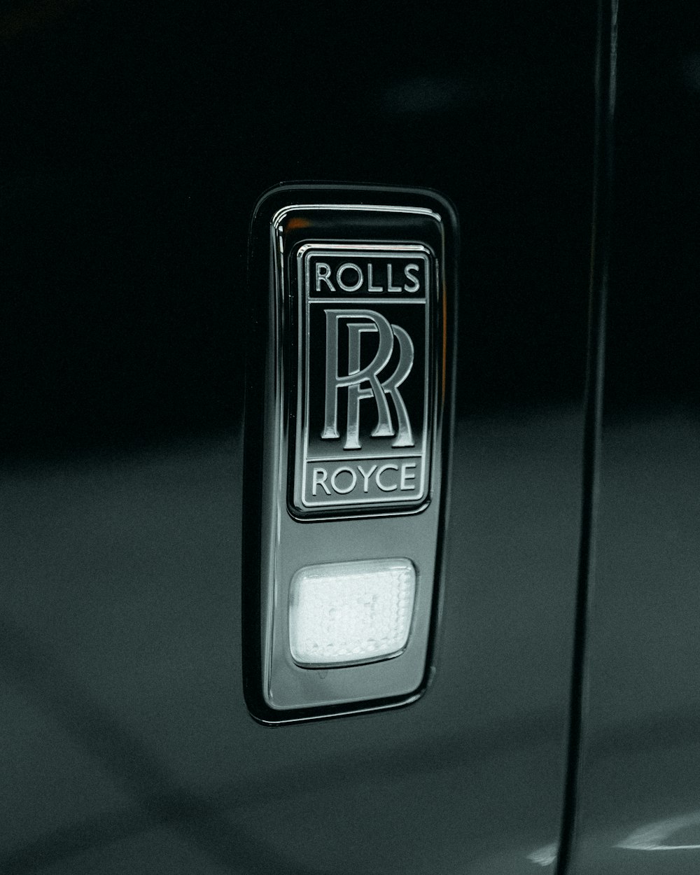 a rolls royce emblem on the door of a rolls royce car
