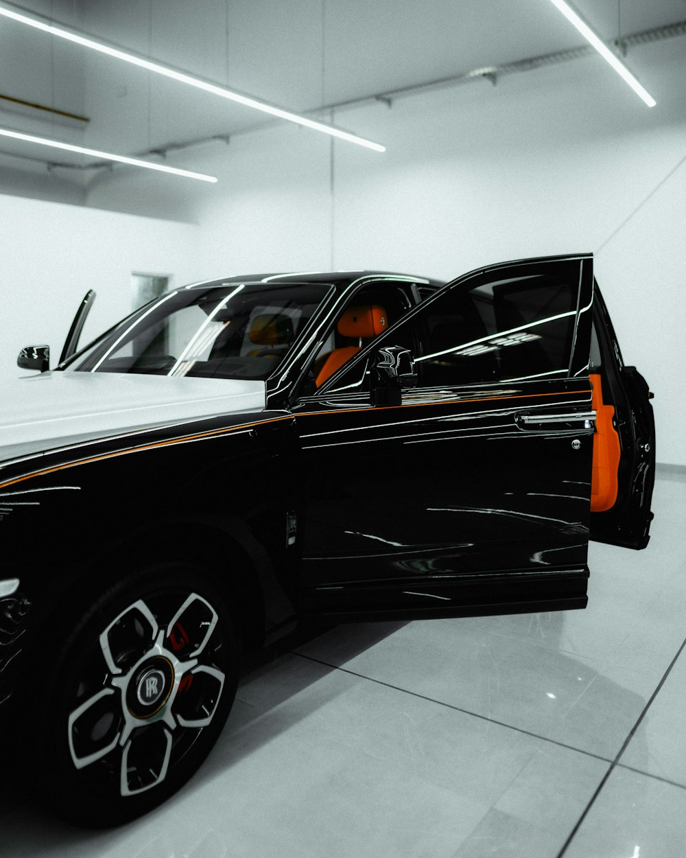 a black truck is parked in a white room