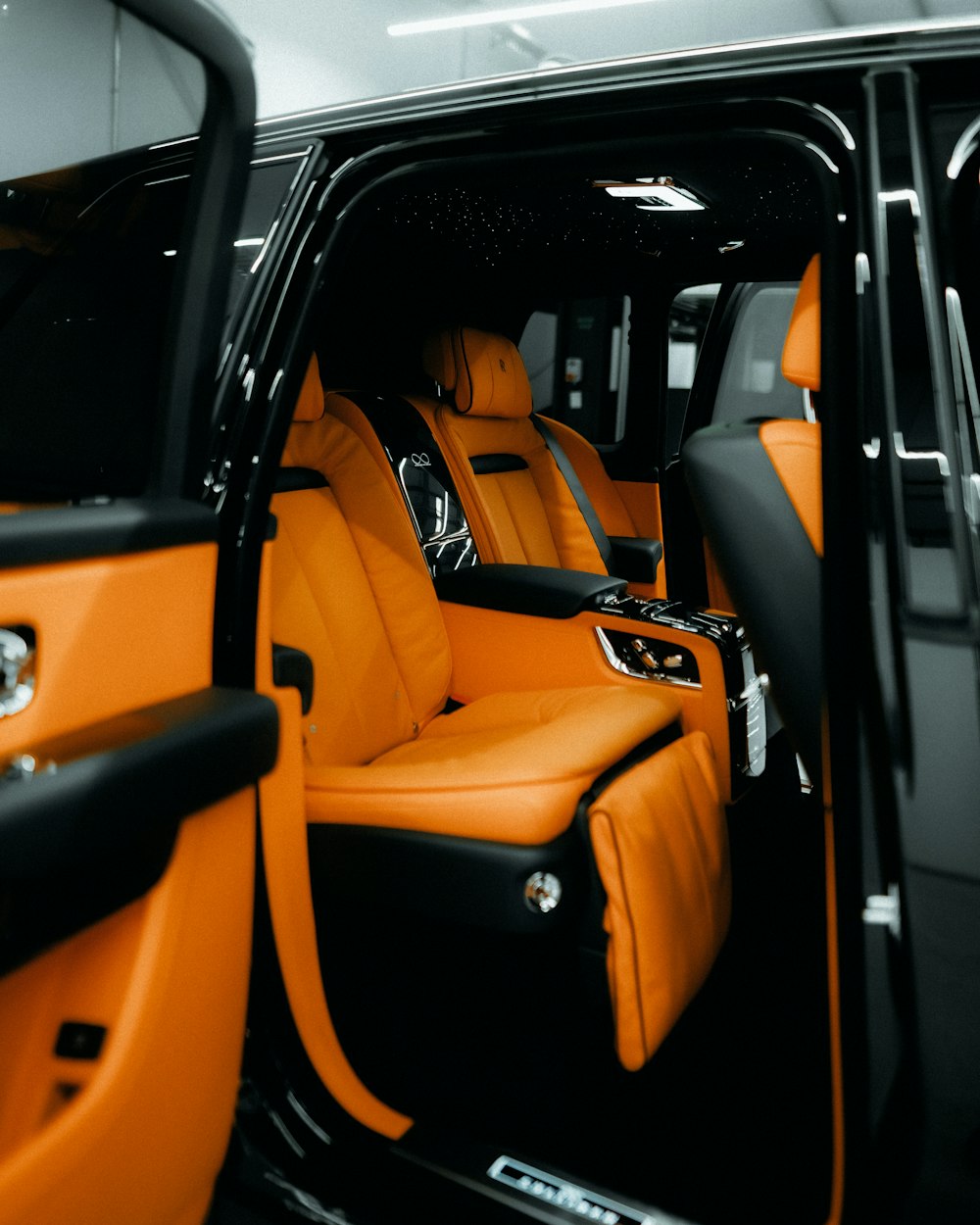 the interior of a vehicle with orange leather seats