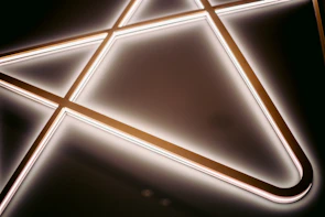 Subtle fine-line constellation drawing glowing softly on an ivory textured background