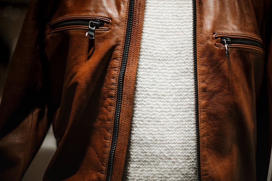Close-up of a handcrafted urban jacket with detailed stitching in a minimalist studio setting