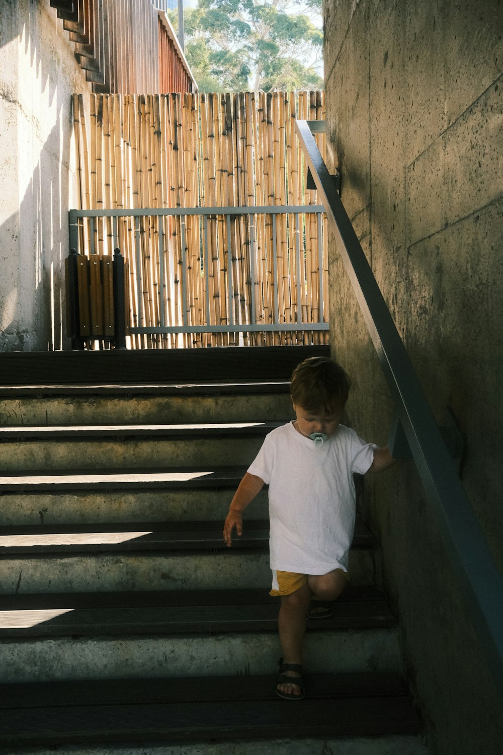 a little boy that is standing on some stairs