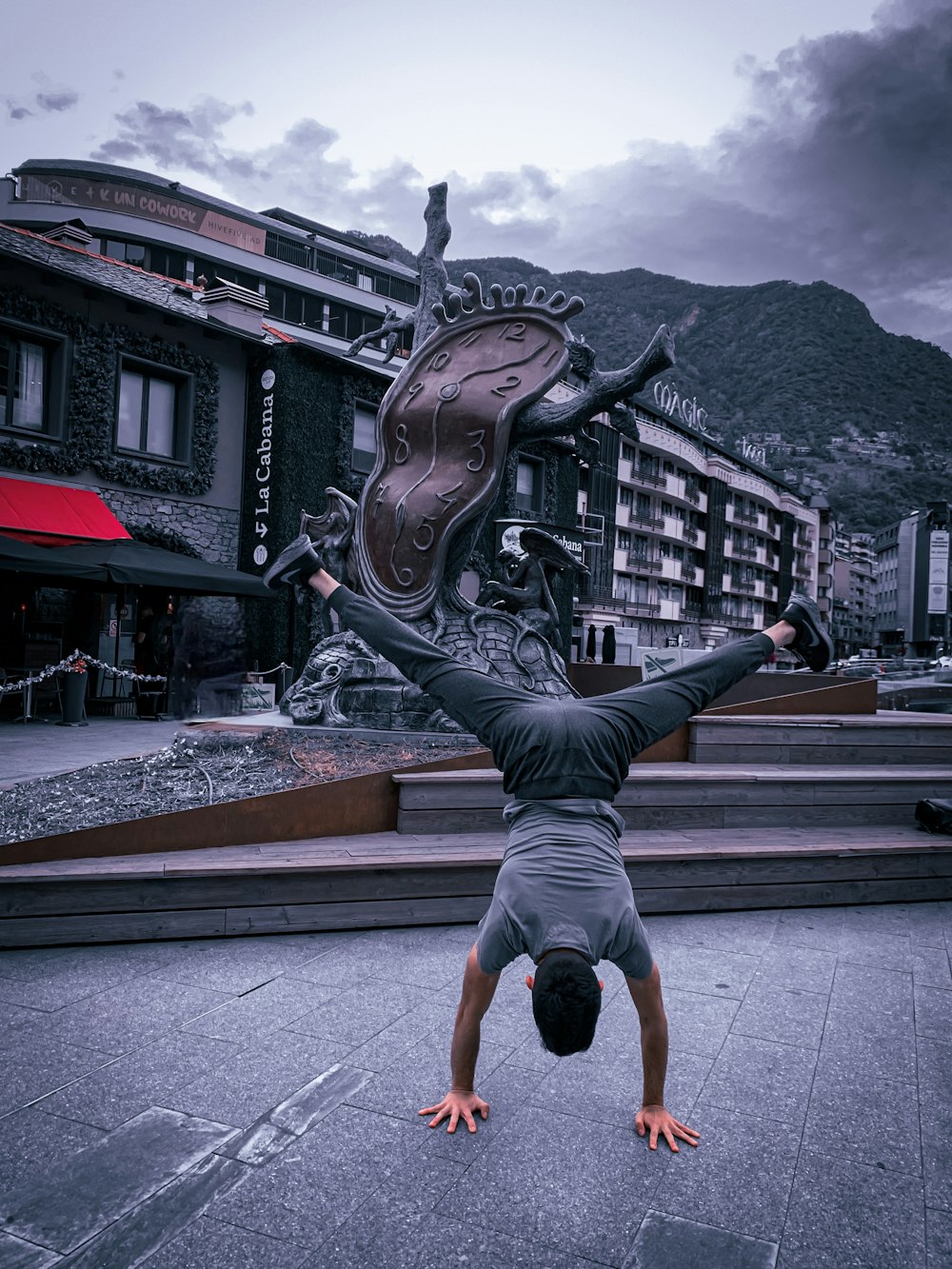 a man doing a handstand in front of a building