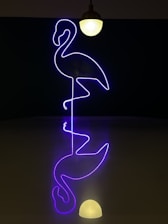 A vibrant pink flamingo logo on a stylish, modern office wall.