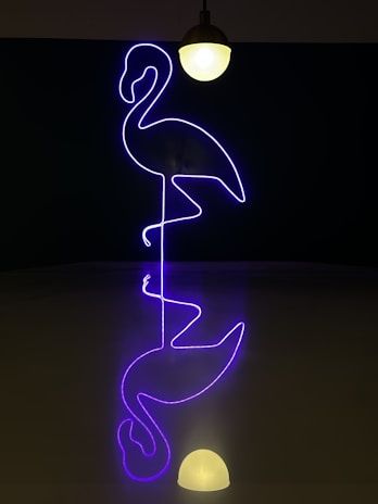 A vibrant pink flamingo logo on a stylish, modern office wall.