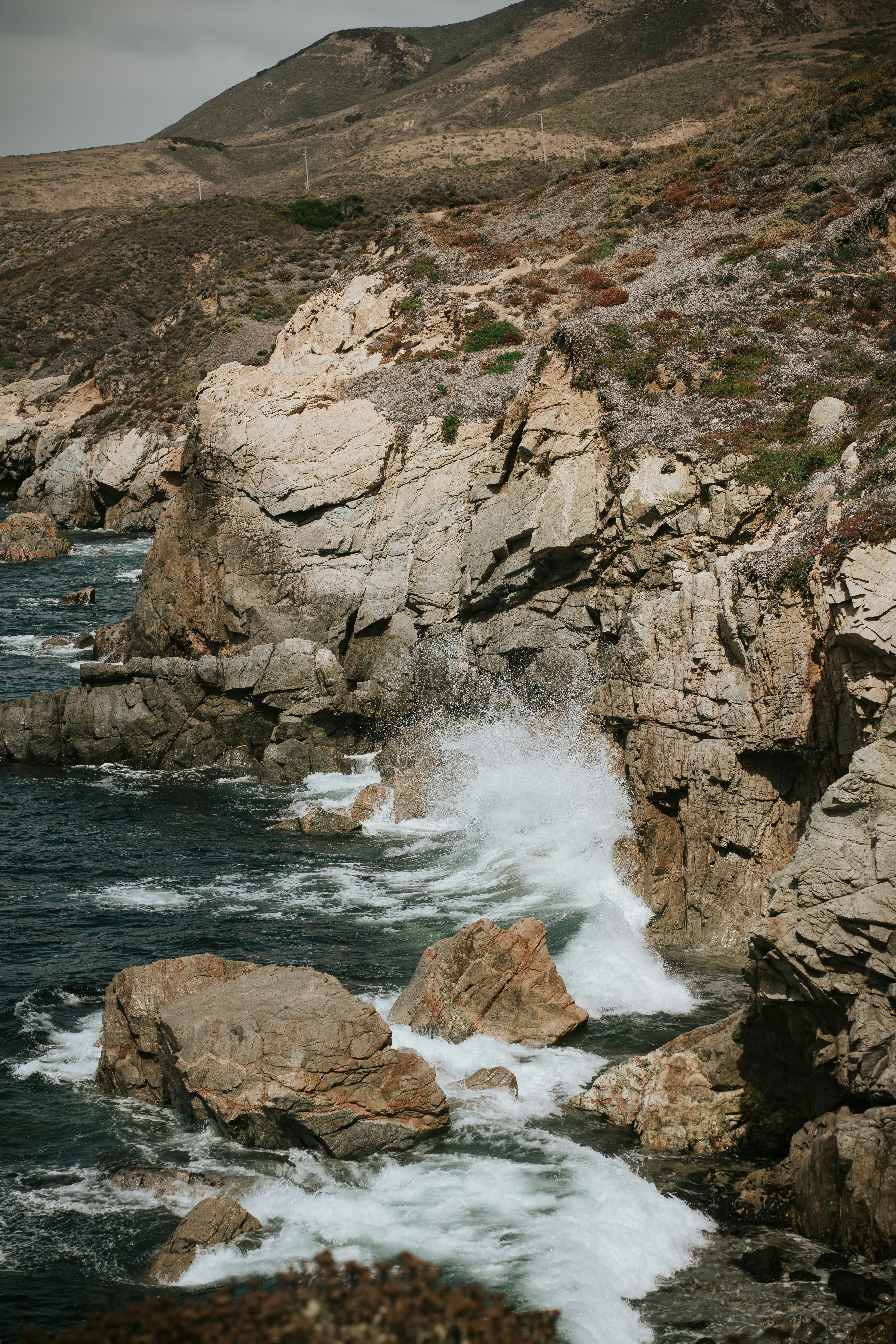 A large body of water surrounded by rocks photo – Free Landscape Image ...