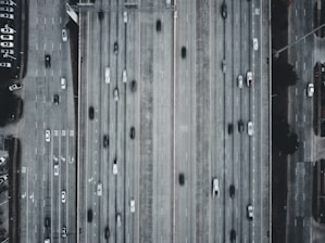 Aerial view of a busy highway with various trucks and transport vehicles moving smoothly.