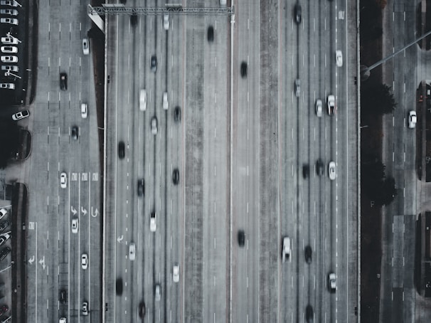 A drone shot of a busy highway filled with cars.