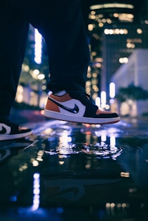 A person walking in stylish sneakers on a city street.