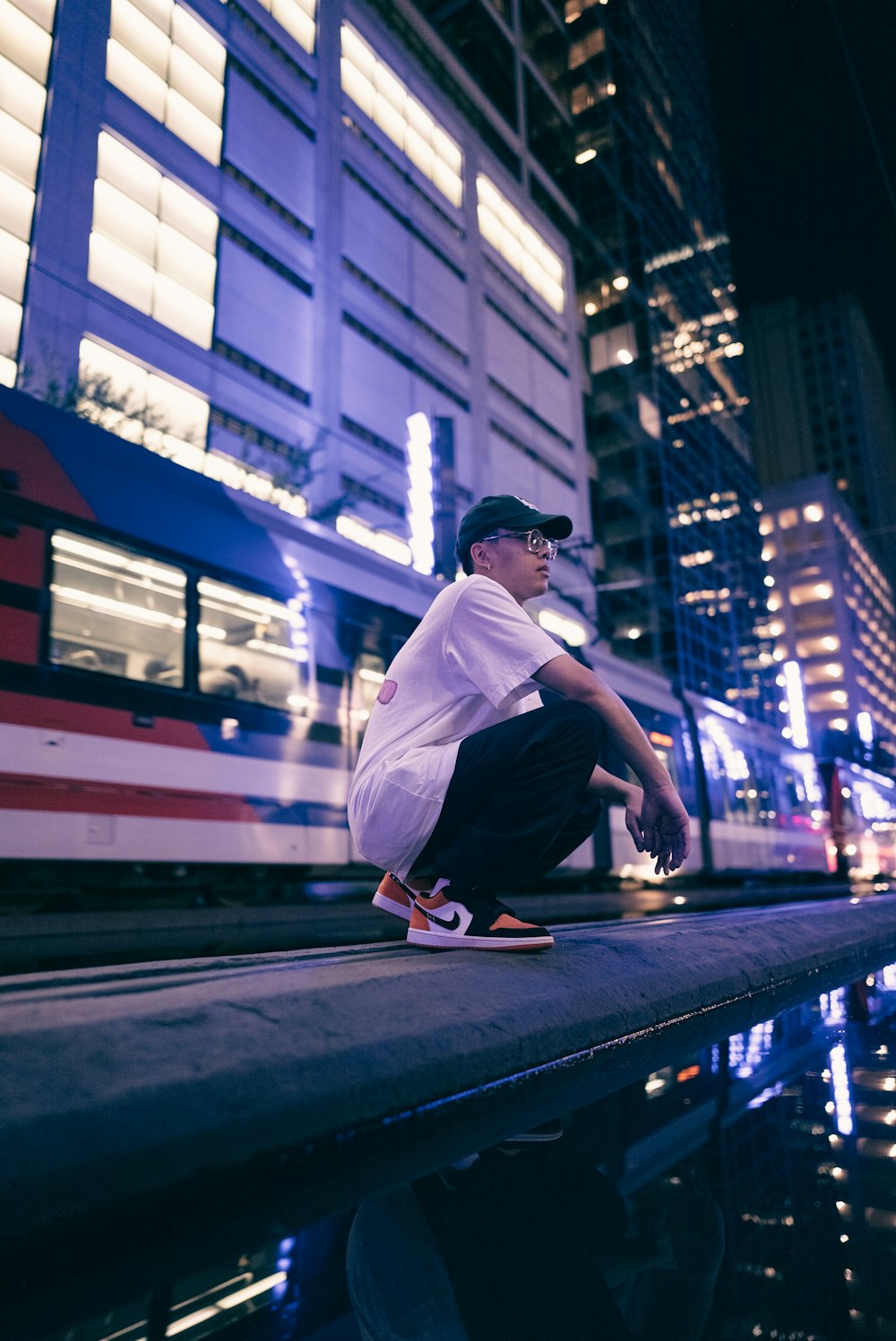 a man riding a skateboard down a street next to a tall building