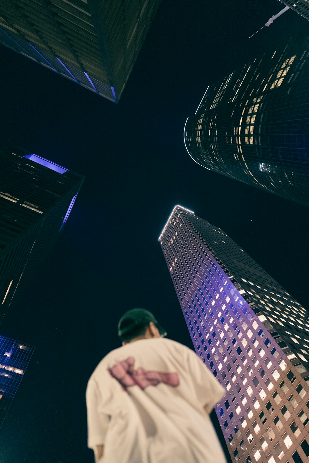a man standing in front of tall buildings