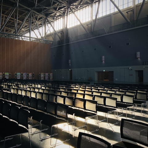 Team professionally cleaning a vibrant event venue with sunlight streaming through large windows.