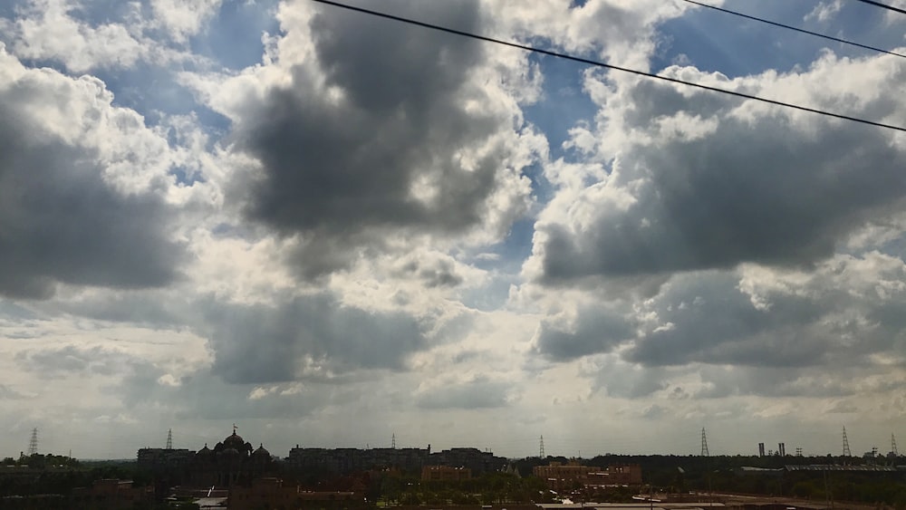 a view of a cloudy sky and some power lines