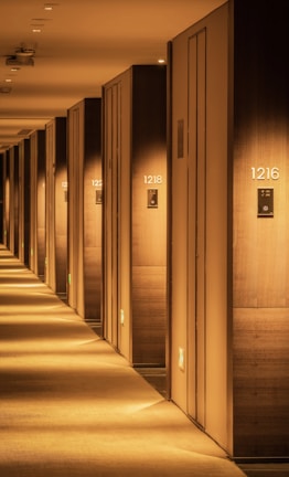Bright, spacious self storage hallway with numbered doors.