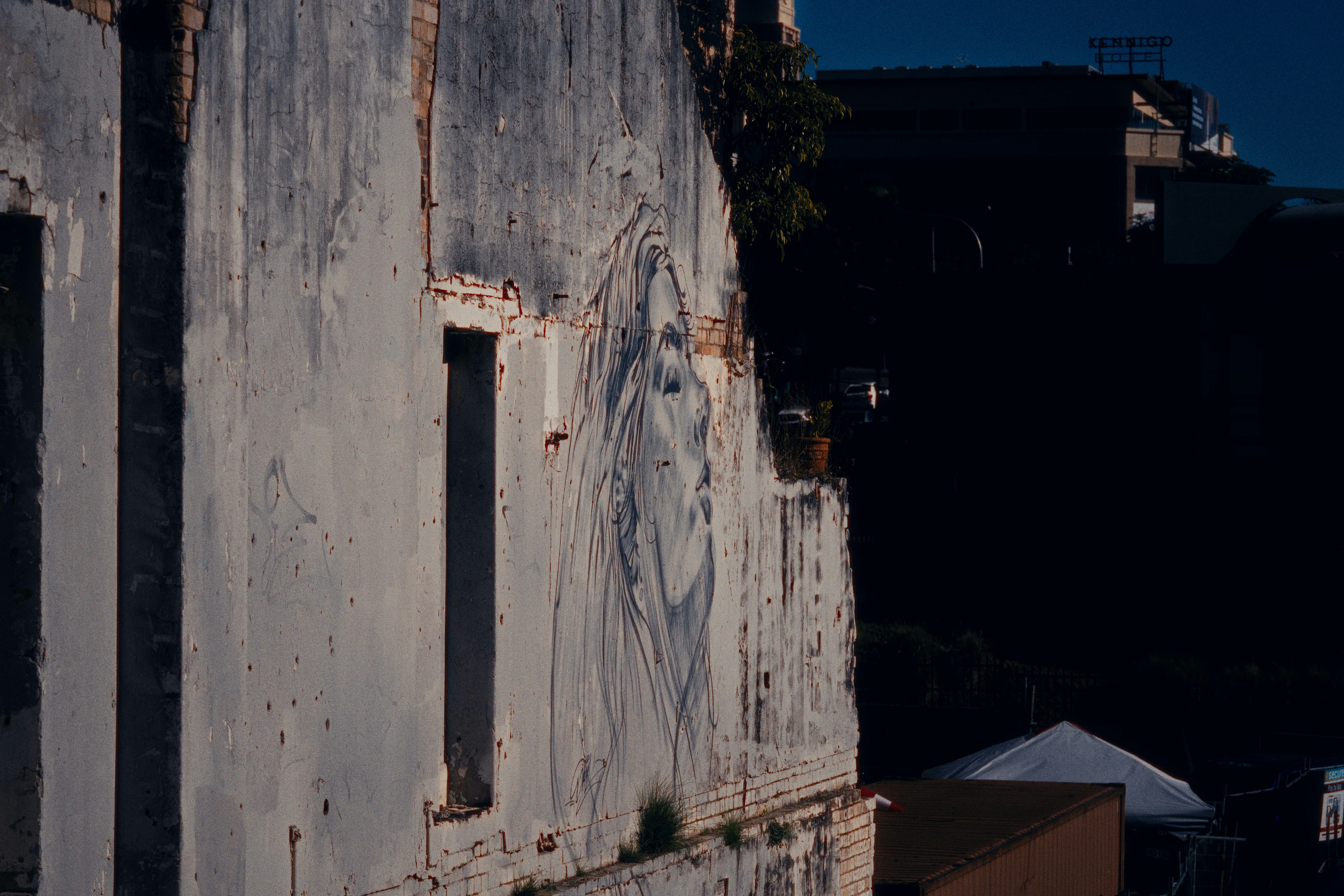 an old building with graffiti on the side of it